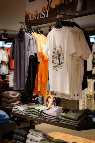 a bunch of shirts on a rack in a store at Brouwersdam Stay in Ouddorp