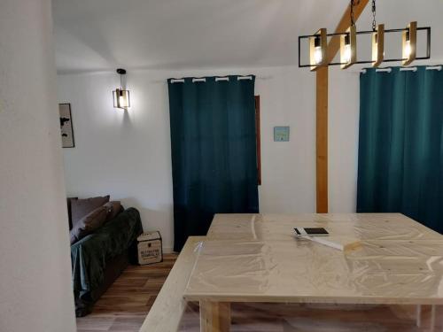 a dining room with a table and blue curtains at A Pieve in Vico