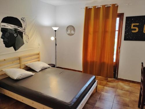 a bed in a room with a painting on the wall at A Pieve in Vico
