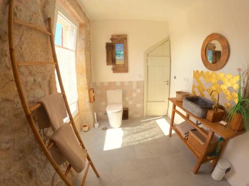 a bathroom with a sink and a toilet in a room at Hideaway Galicia Corrubedo in Corrubedo