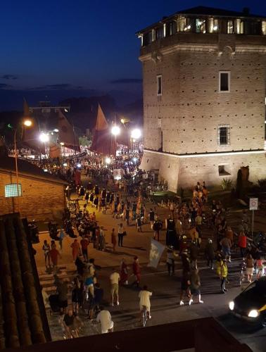 a crowd of people standing outside a building at night at Dalla Torre al mare in Cervia