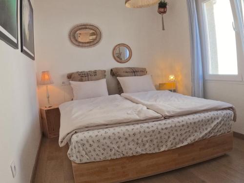a bedroom with a large bed with white sheets and pillows at Hideaway Galicia Corrubedo in Corrubedo