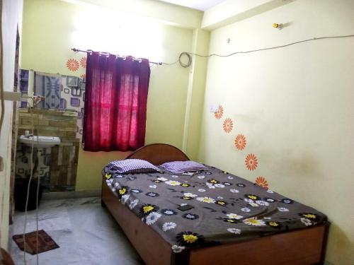 a small bedroom with a bed in a room at Amar Priya guest house in Kolkata