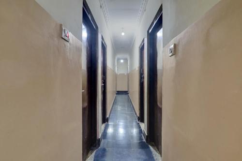 a hallway with a long aisle with blue tiles at SPOT ON Gokul Residency Near Secunderabad Railway Station in Hyderabad