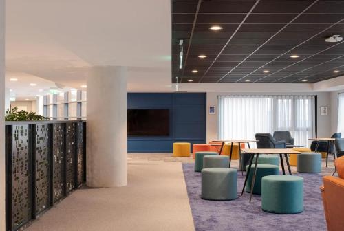 a lobby with tables and chairs and a tv at Cosy Ensuite Bedrooms at Aspen House in Dublin in Dublin