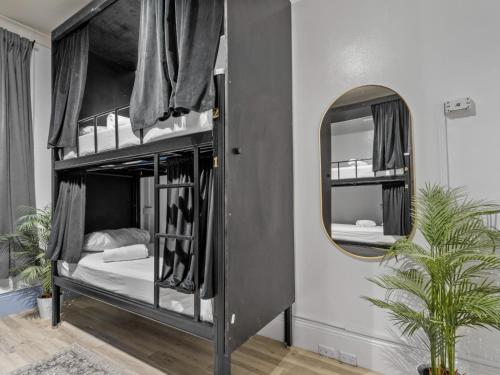 a bedroom with two bunk beds and a mirror at Sydney Pod Hotels - Darling Harbour in Sydney