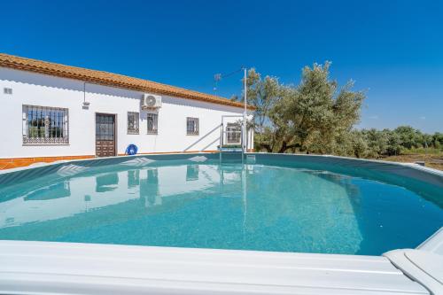 a swimming pool in front of a house at Casita Los Garranchos in Córdoba