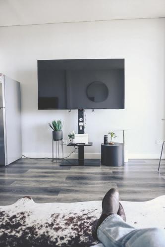 a person laying on the floor in a living room at VistaMirage - Mystic Ridge Estate in Bywong