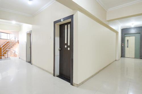 a hallway with a door in a building at FabExpress Yashraj Inn - BJS College in Wagholi