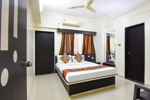 a bedroom with a large bed in a room at FabExpress Yashraj Inn - BJS College in Wagholi