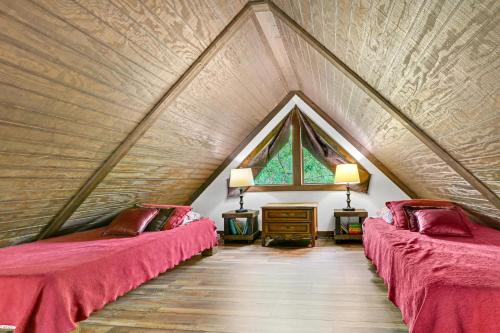 a room with two beds in a attic at Clutter Falls Retreat - Guest House in New Braunfels