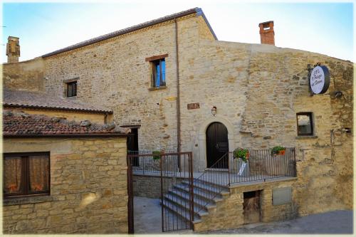 a stone building with a staircase in front of it at Il Palazzo del Barone - Stanza dei Maiorana in Pietrapertosa