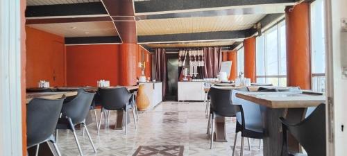 a restaurant with tables and chairs in a room at Thesleepingbeautyhotel in Joshīmath