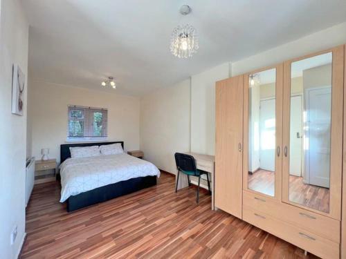 a bedroom with a bed and a desk and a chair at London Central Acton House in London