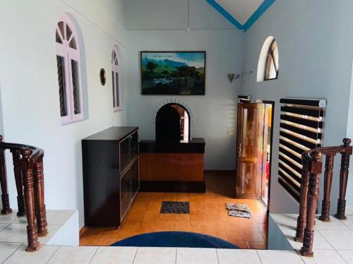 a living room with a table and a fireplace at BOB Leisure in Ooty