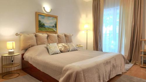 a bedroom with a large bed with two pillows on it at Art Depandansa in Zadar