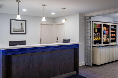 a bar with a blue counter in a room at Travelodge Suites by Wyndham Saint John in Saint John