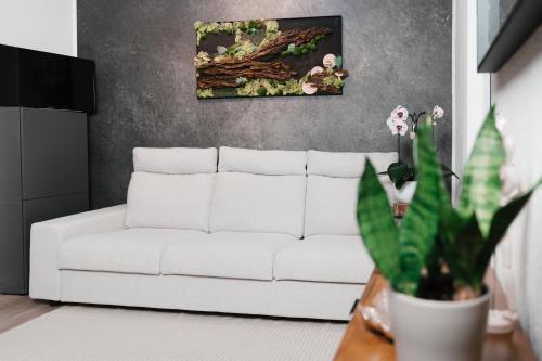 a white couch in a living room with a plant at Waldstübchen Quedlinburg in Quedlinburg