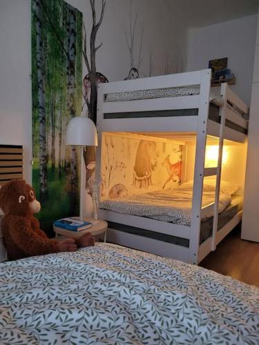 a teddy bear sitting on a bed in a bedroom at Waldstübchen Quedlinburg in Quedlinburg