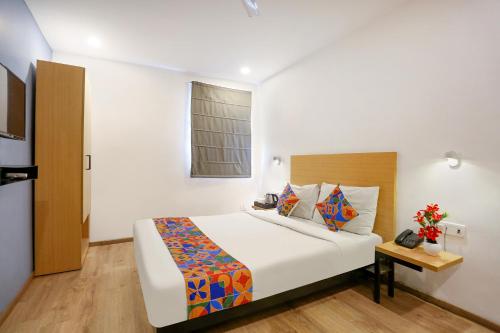 a bedroom with a large white bed and a window at FabHotel Vivek in Muthiganj