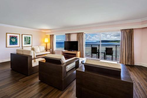 a living room with a view of the ocean at Hilton Guam Resort & Spa in Tumon