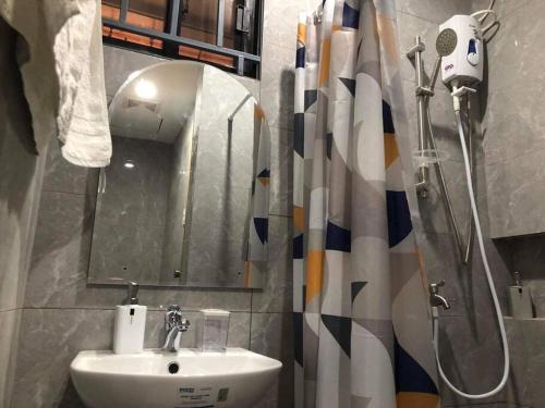 a bathroom with a sink and a shower at 3-Bedroom bungalow in San Fernando Pampanga in San Fernando