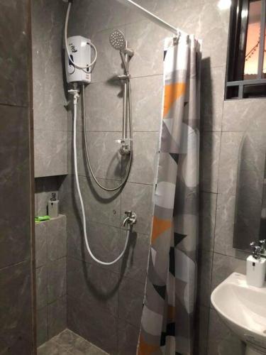 a shower in a bathroom with a shower curtain at 3-Bedroom bungalow in San Fernando Pampanga in San Fernando