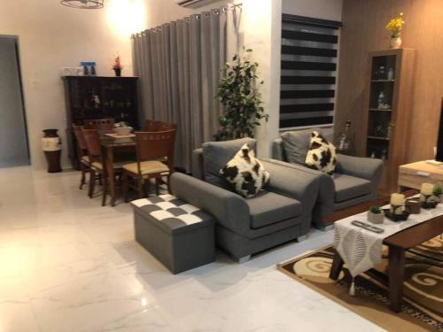 a living room with a couch and a table and chairs at 3-Bedroom bungalow in San Fernando Pampanga in San Fernando