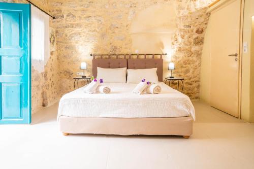 a bedroom with a bed with two dolls on it at Casa Panstel in Rethymno