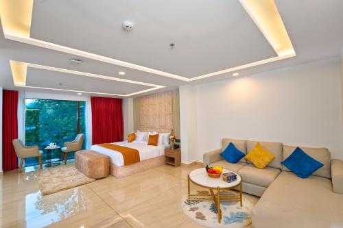 a hotel room with a bed and a couch at Serene Horizon in Thekkady
