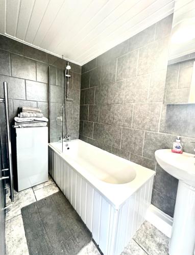 a bathroom with a bath tub and a sink at Arthur Street in Hull