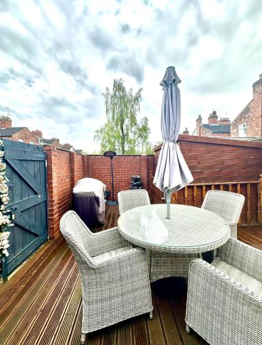a patio with a table and chairs on a deck at Arthur Street in Hull