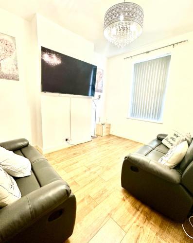 a living room with a couch and a flat screen tv at Arthur Street in Hull