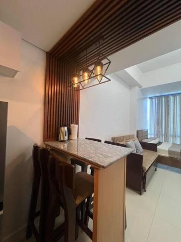 a kitchen with a table and chairs in a room at Studio Unit located at 38 Park Avenue Condominium in IT Park Cebu in Cebu City