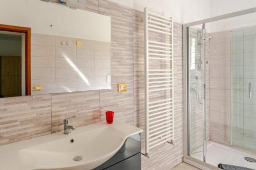 a bathroom with a sink and a glass shower at gite Da Clara in Serrazzano