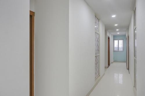 a hallway of a house with white walls at Collection O 83129 Hotel Galaxy Hospitality in Kharadi