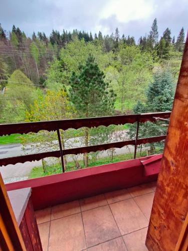 a balcony with a view of a forest at Chata Pod Kwiatkiem in Zawoja