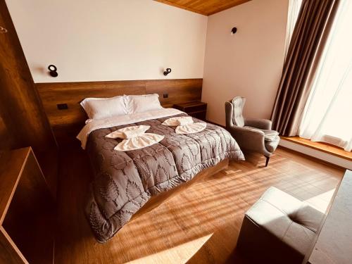 a bedroom with a bed and a chair at Bujtina Terthorja in Theth
