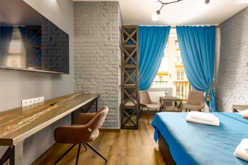 a room with two beds and a table and chairs at Karlovy Charme Inn by Rentez in Karlovy Vary