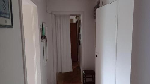 a hallway with a white door and a room with a hallway at Förvaltarbostaden in Åtvidaberg