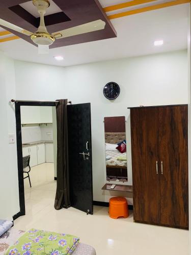 a room with a bed and two cabinets and a ceiling at Manjushree Guest House in Ujjain
