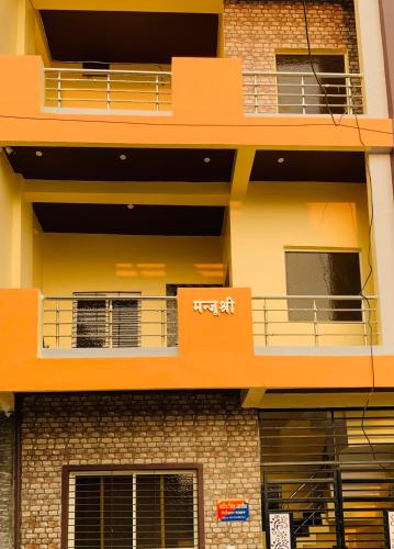 an orange building with balconies on the side of it at Manjushree Guest House in Ujjain