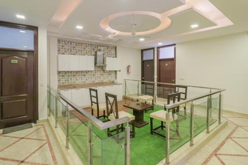 a dining room with a glass table and chairs at Collection O Hotel Radiant Inn in Gurgaon