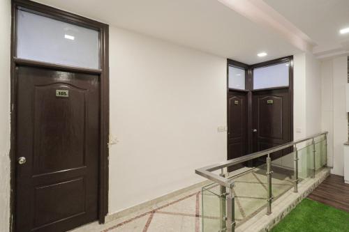 a pair of doors in a hallway with grass at Collection O Hotel Radiant Inn in Gurgaon