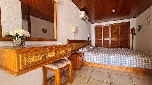 a bedroom with a bed with a dresser and a mirror at Albufeira Sea view (51) in Albufeira