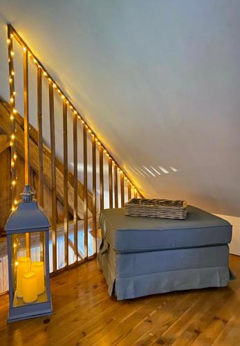a room with a mattress and a lamp and a staircase at Aux petites portes du Morvan in Montlay-en-Auxois