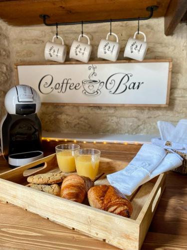 a tray of bread and cups of coffee and croissants at Aux petites portes du Morvan in Montlay-en-Auxois