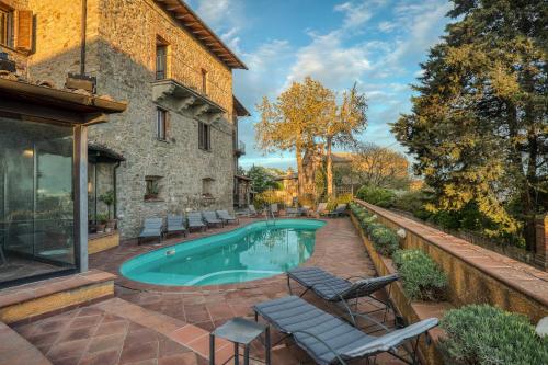 a swimming pool in the backyard of a house at Relais La Fattoria in Castel Rigone