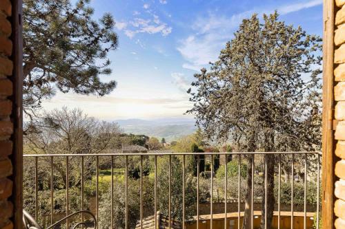 a view from a window of a fence at Relais La Fattoria in Castel Rigone