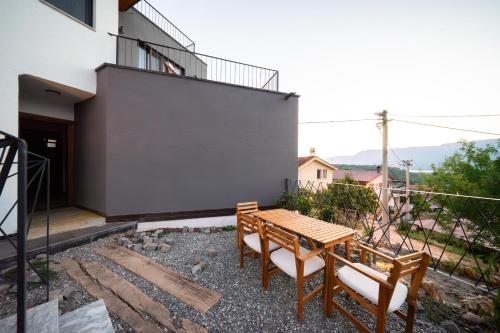 a patio with a wooden table and two benches at Kikonia Art & Suites in Akyaka